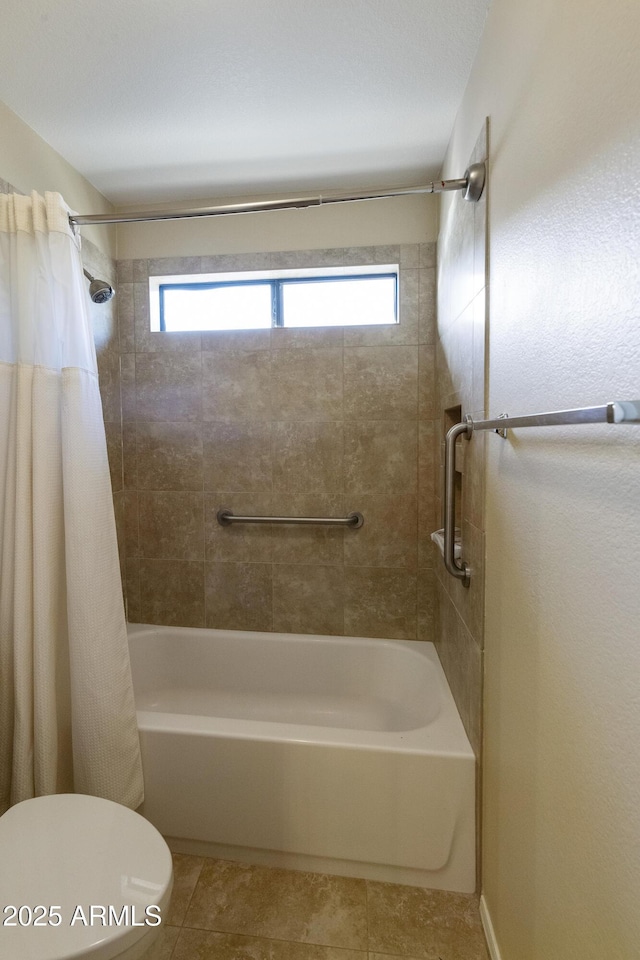 bathroom featuring shower / tub combo with curtain, tile patterned floors, and toilet