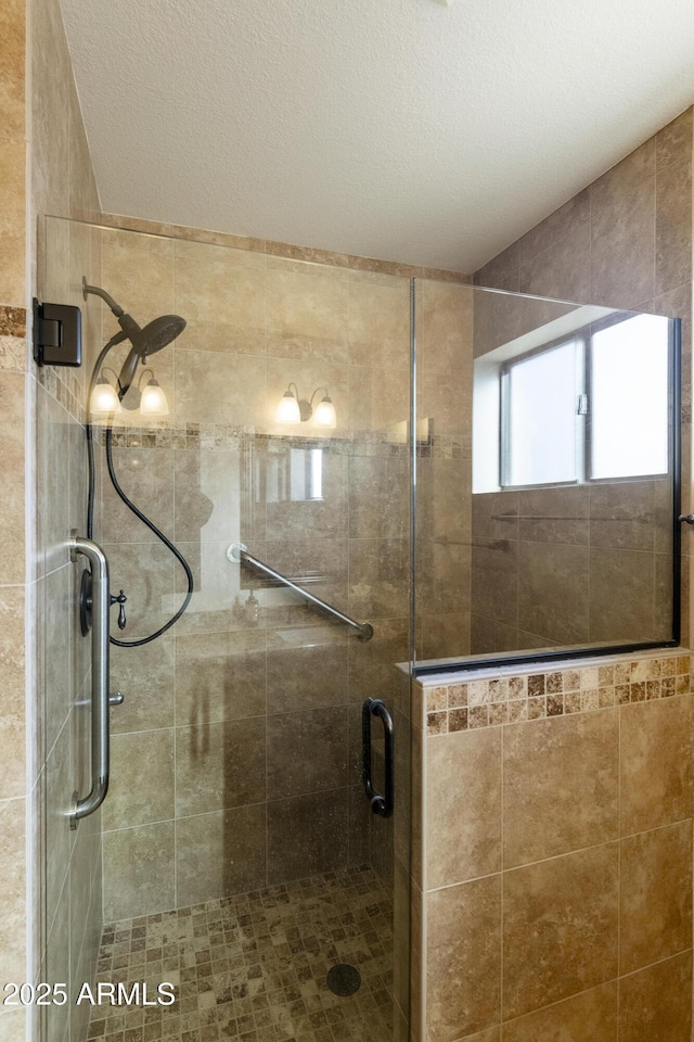 bathroom with a textured ceiling and walk in shower