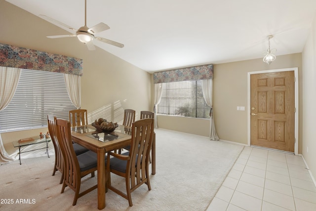 dining area featuring vaulted ceiling, light carpet, and ceiling fan