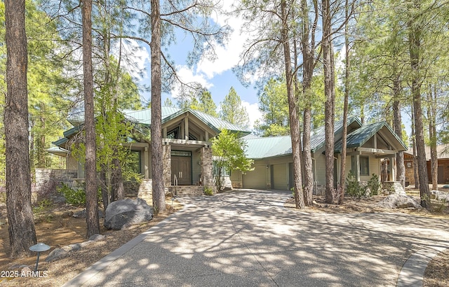 2036 Bessie Kidd Best, Flagstaff, AZ 86005 - mid-century home with an attached garage, driveway, stone siding, and metal roof
