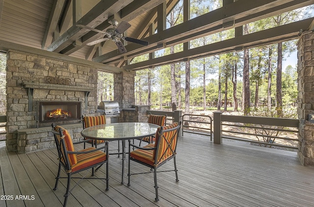 2036 Bessie Kidd Best, Flagstaff, AZ 86005 - wooden terrace with a fireplace, a ceiling fan, outdoor dining area, a grill, and exterior kitchen