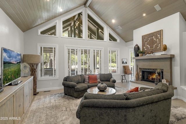 2036 Bessie Kidd Best, Flagstaff, AZ 86005 - living room featuring a warm lit fireplace, wooden ceiling, baseboards, high vaulted ceiling, and light tile patterned flooring