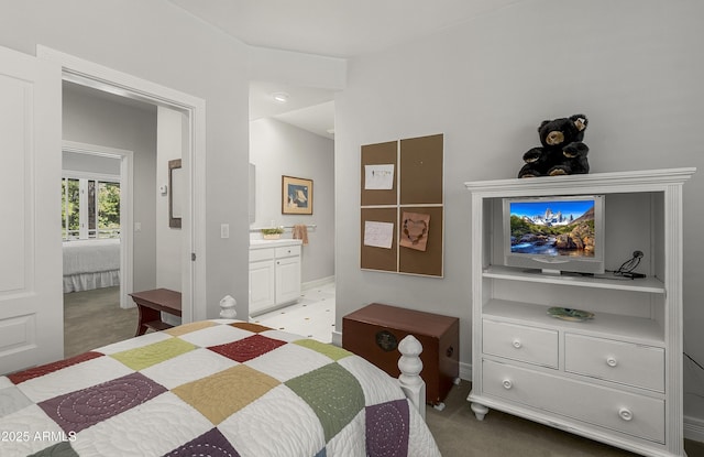 2036 Bessie Kidd Best, Flagstaff, AZ 86005 - bedroom with light colored carpet, baseboards, and connected bathroom