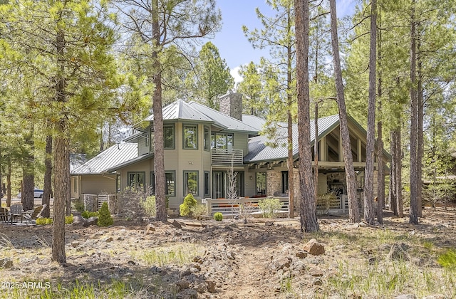 2036 Bessie Kidd Best, Flagstaff, AZ 86005 - view of front of home with a chimney, metal roof, a standing seam roof, and stone siding