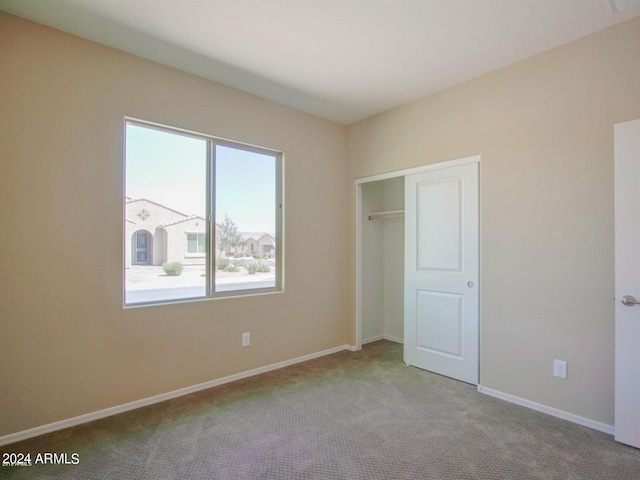 unfurnished bedroom with a closet and carpet