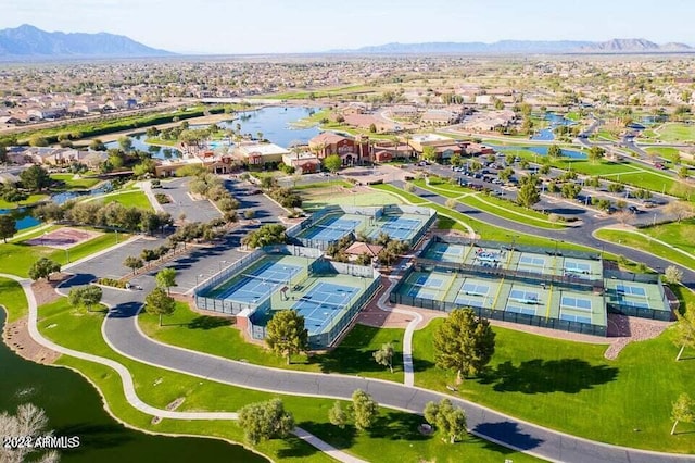 birds eye view of property with a water and mountain view