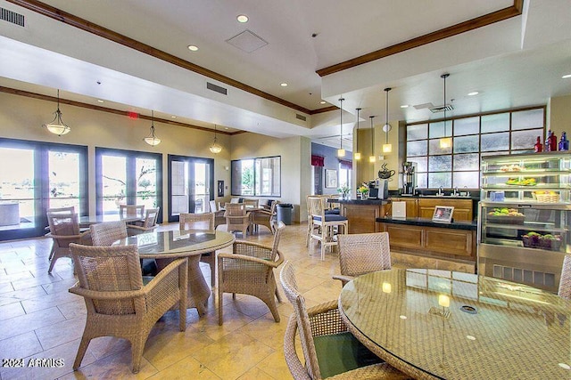 tiled dining room with crown molding and a high ceiling