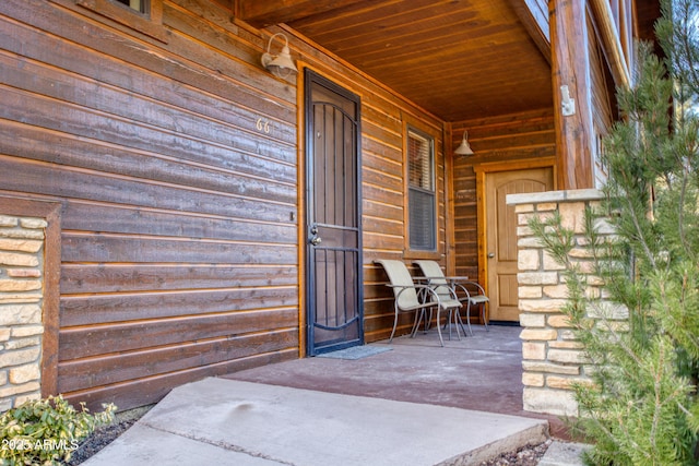 doorway to property featuring covered porch