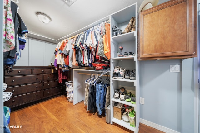 walk in closet featuring light hardwood / wood-style floors