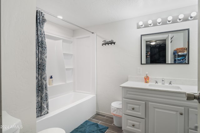 full bathroom featuring vanity, shower / tub combo with curtain, a textured ceiling, and toilet