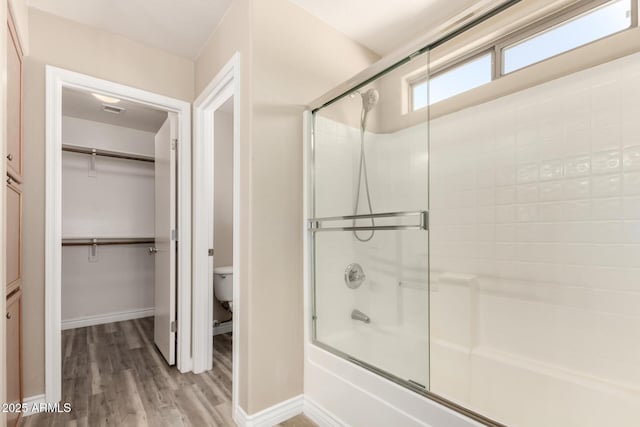 1968 E Emily Ln, Gilbert, AZ 85295 - full bathroom with wood finished floors, baseboards, toilet, shower / bath combination with glass door, and a spacious closet