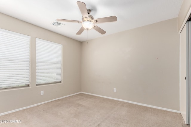 1968 E Emily Ln, Gilbert, AZ 85295 - empty room with visible vents, baseboards, ceiling fan, plenty of natural light, and light colored carpet