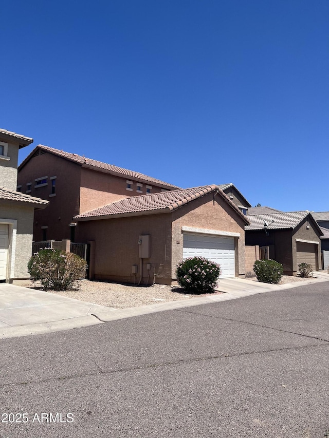 1968 E Emily Ln, Gilbert, AZ 85295 - view of front facade with stucco siding, driveway, a tile roof, and a garage