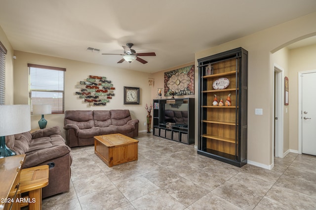 living room with ceiling fan and light tile patterned floors