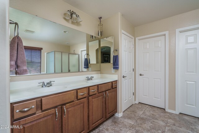 bathroom featuring tile patterned floors, vanity, and walk in shower