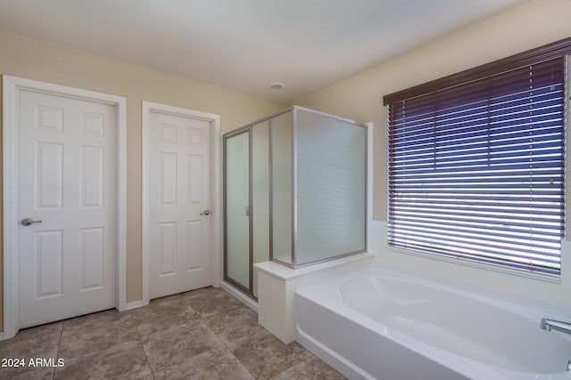 bathroom featuring tile patterned floors and independent shower and bath