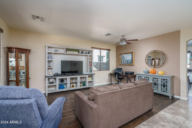 living room with ceiling fan and dark hardwood / wood-style flooring