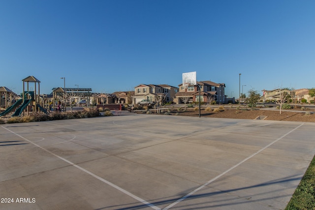 view of sport court featuring a playground