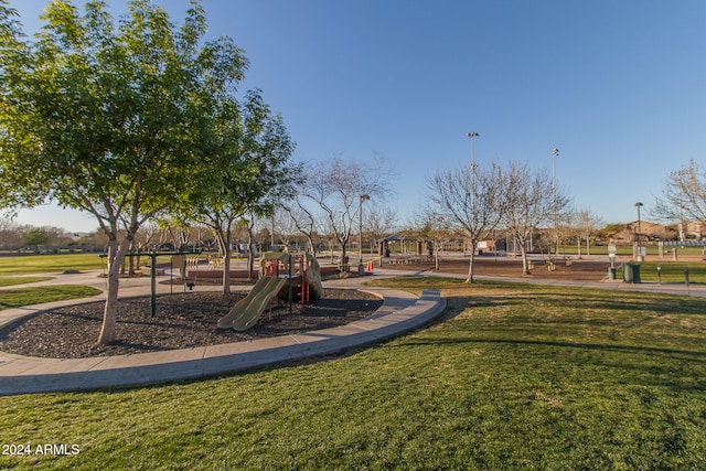 view of jungle gym featuring a lawn