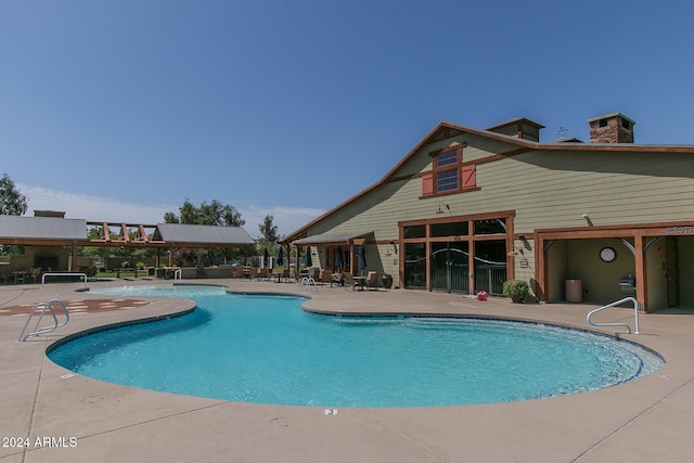 view of swimming pool with a patio area