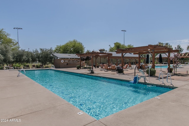 view of swimming pool featuring a patio area and a pergola