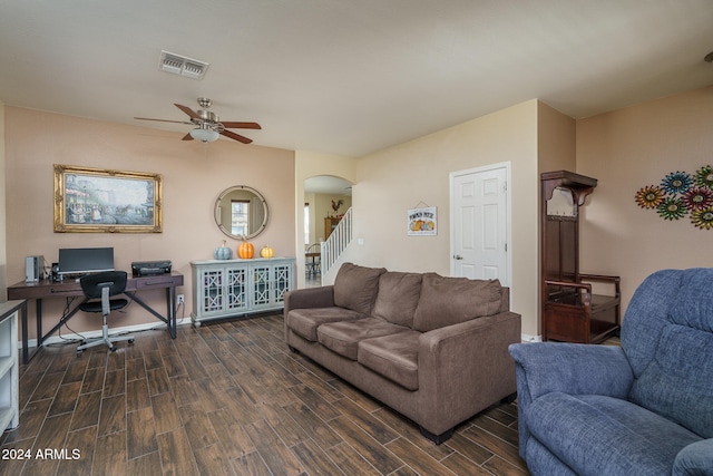 living room featuring ceiling fan and dark hardwood / wood-style flooring