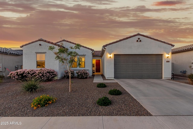 17896 W Amberwood Dr, Goodyear, AZ 85338 - mediterranean / spanish-style house with concrete driveway, a tile roof, an attached garage, and stucco siding