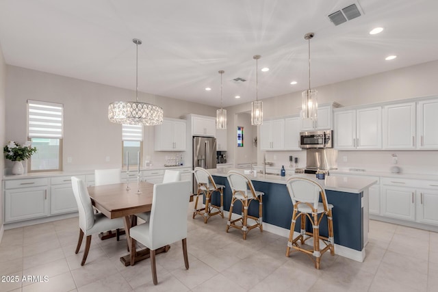 17896 W Amberwood Dr, Goodyear, AZ 85338 - dining area featuring light tile patterned floors, a notable chandelier, visible vents, and recessed lighting