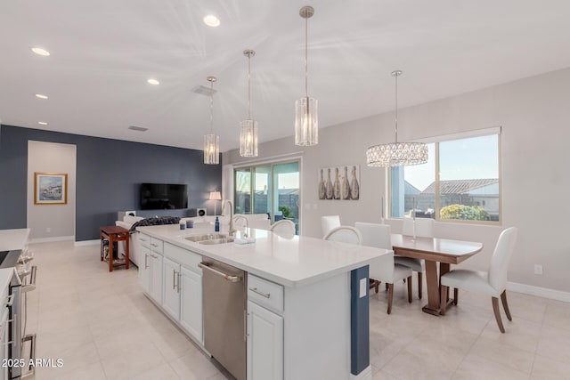 17896 W Amberwood Dr, Goodyear, AZ 85338 - kitchen featuring an inviting chandelier, open floor plan, light countertops, appliances with stainless steel finishes, and a sink