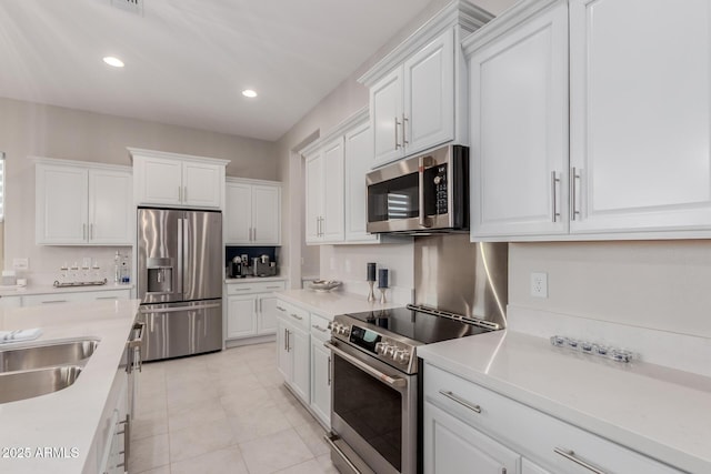 17896 W Amberwood Dr, Goodyear, AZ 85338 - kitchen with recessed lighting, light tile patterned floors, light countertops, white cabinets, and appliances with stainless steel finishes
