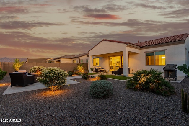 17896 W Amberwood Dr, Goodyear, AZ 85338 - rear view of property with a patio area, a tile roof, fence, and an outdoor hangout area