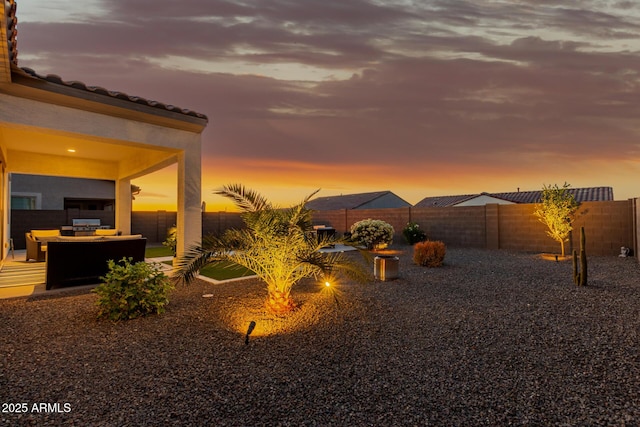 17896 W Amberwood Dr, Goodyear, AZ 85338 - yard at dusk featuring a fenced backyard and a patio