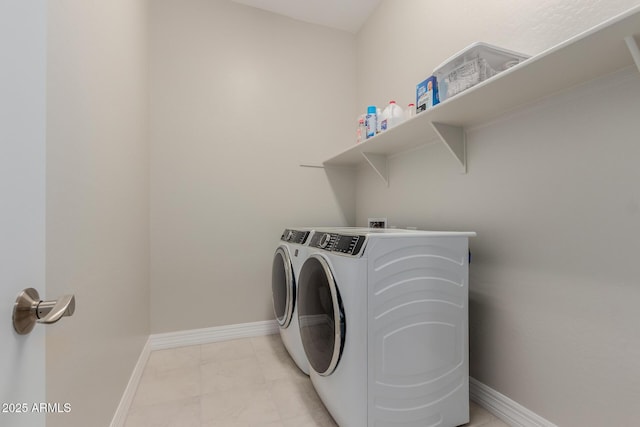 17896 W Amberwood Dr, Goodyear, AZ 85338 - clothes washing area featuring laundry area, washing machine and clothes dryer, and baseboards