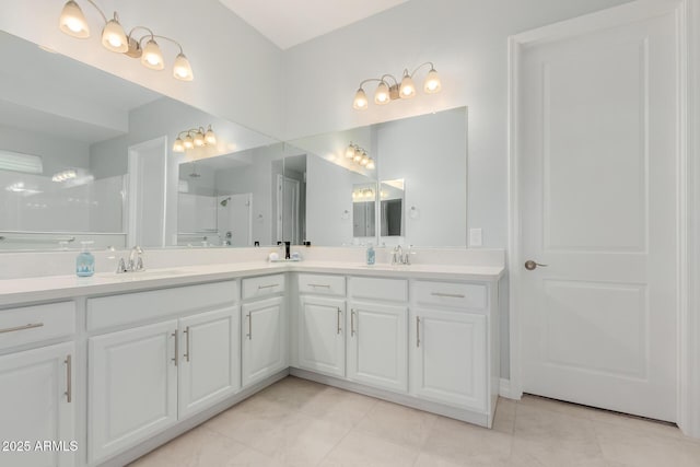 17896 W Amberwood Dr, Goodyear, AZ 85338 - full bath with walk in shower, tile patterned flooring, double vanity, and a sink