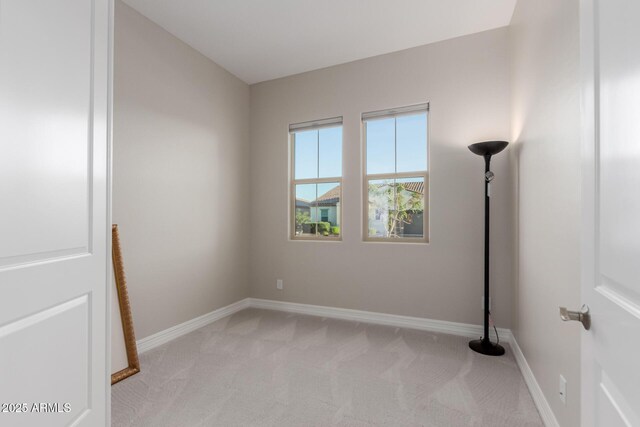 17896 W Amberwood Dr, Goodyear, AZ 85338 - unfurnished room featuring baseboards and light carpet