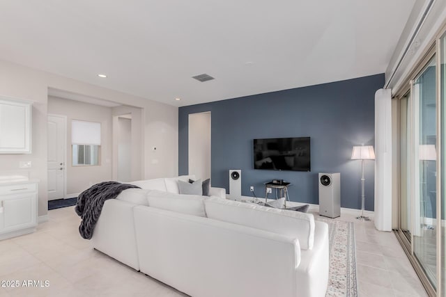 17896 W Amberwood Dr, Goodyear, AZ 85338 - living room with recessed lighting, light tile patterned floors, visible vents, and baseboards