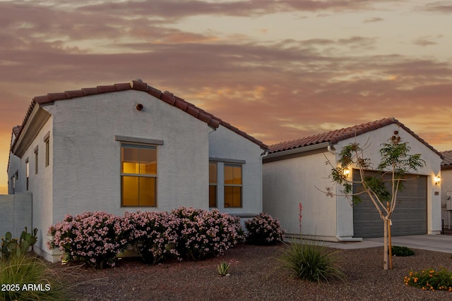 17896 W Amberwood Dr, Goodyear, AZ 85338 - mediterranean / spanish house featuring a garage, driveway, stucco siding, and a tile roof