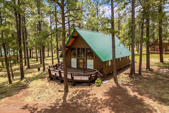 exterior space with a deck and metal roof
