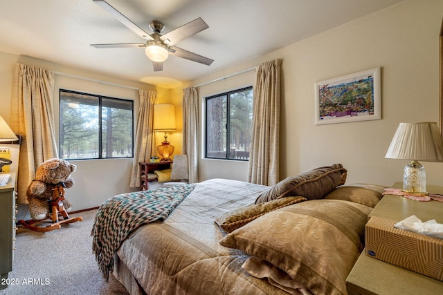 carpeted bedroom with baseboards, multiple windows, and ceiling fan
