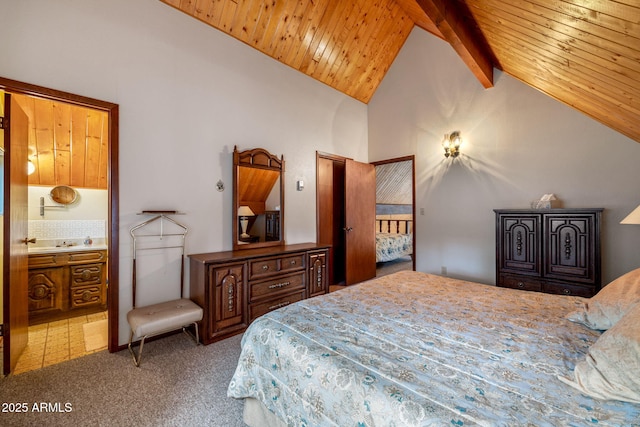 bedroom featuring high vaulted ceiling, beam ceiling, ensuite bath, wooden ceiling, and light colored carpet
