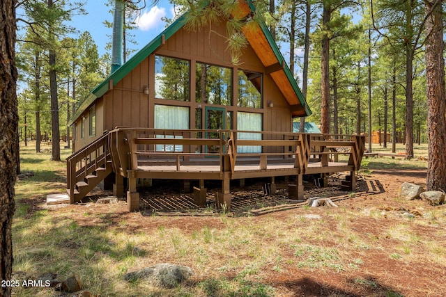 rear view of property with a wooden deck