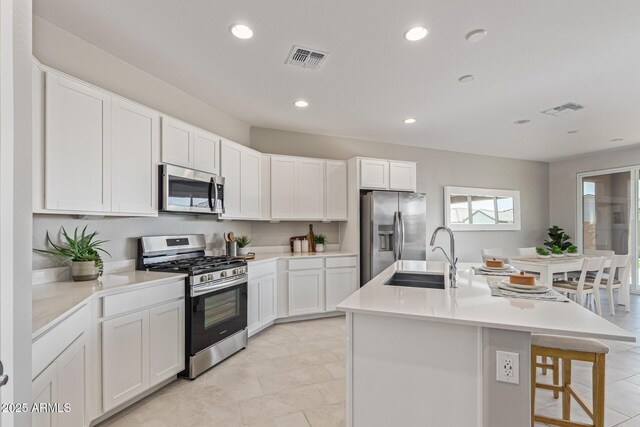 4371 E Enmark Dr, San Tan Valley, AZ 85143 - kitchen featuring appliances with stainless steel finishes, recessed lighting, a center island with sink, light countertops, and white cabinets