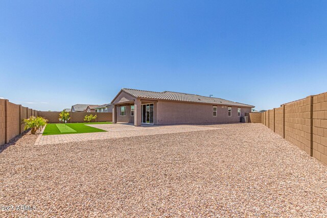 4371 E Enmark Dr, San Tan Valley, AZ 85143 - back of house featuring a fenced backyard, a tiled roof, a patio, and stucco siding