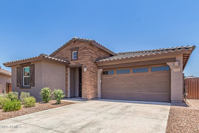 4371 E Enmark Dr, San Tan Valley, AZ 85143 - view of front facade with a tile roof, concrete driveway, an attached garage, and stucco siding