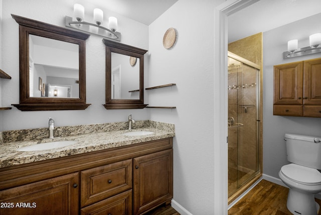 1408 N 62nd Pl, Mesa, AZ 85205 - full bathroom with toilet, wood finished floors, a shower stall, double vanity, and baseboards