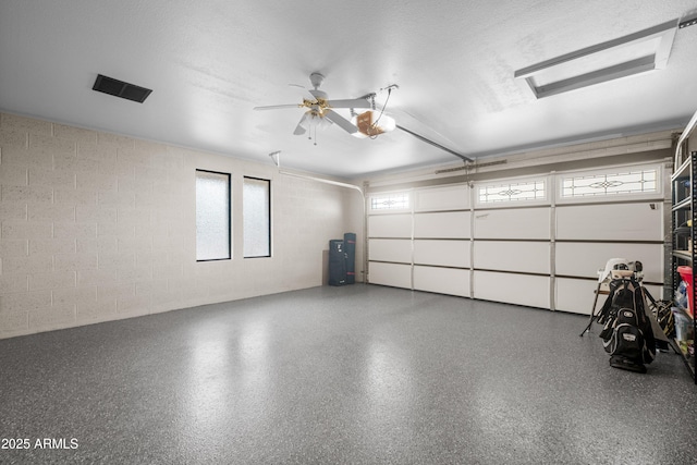 1408 N 62nd Pl, Mesa, AZ 85205 - garage with a garage door opener, concrete block wall, and ceiling fan