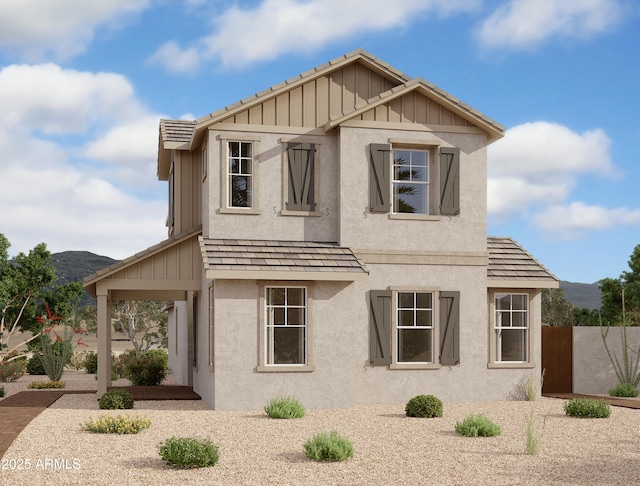 view of front of home with board and batten siding, fence, and stucco siding