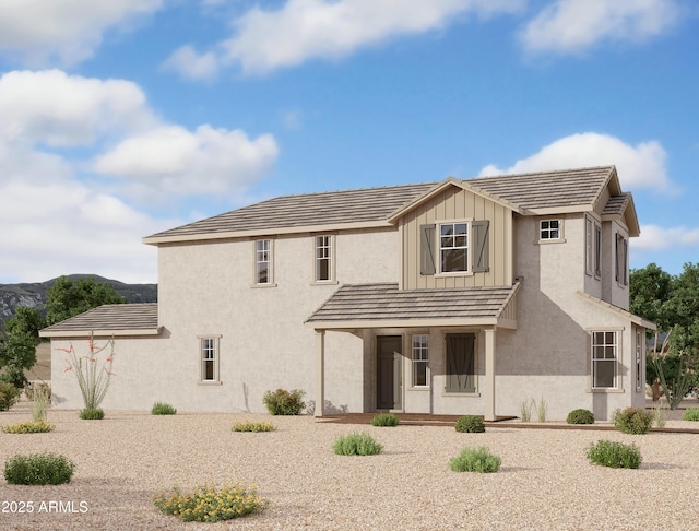 rear view of property featuring board and batten siding and stucco siding