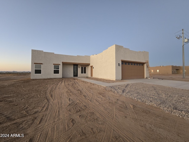 pueblo-style house with a garage