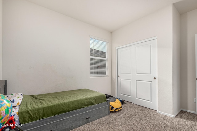 carpeted bedroom with a closet